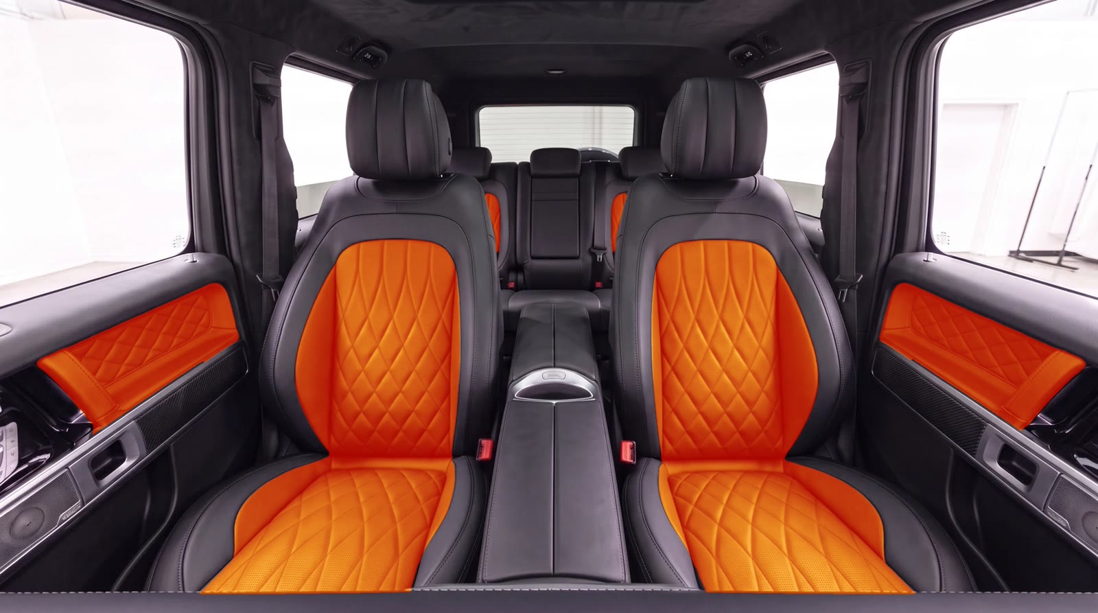 G-Wagon interior visualization: orange seat centers and door inserts with the factory black seat band, AMG-style pattern