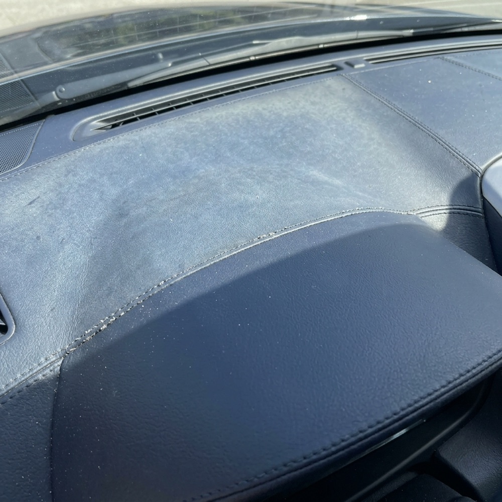 A dark blue dashboard faded lighter on top by the sun