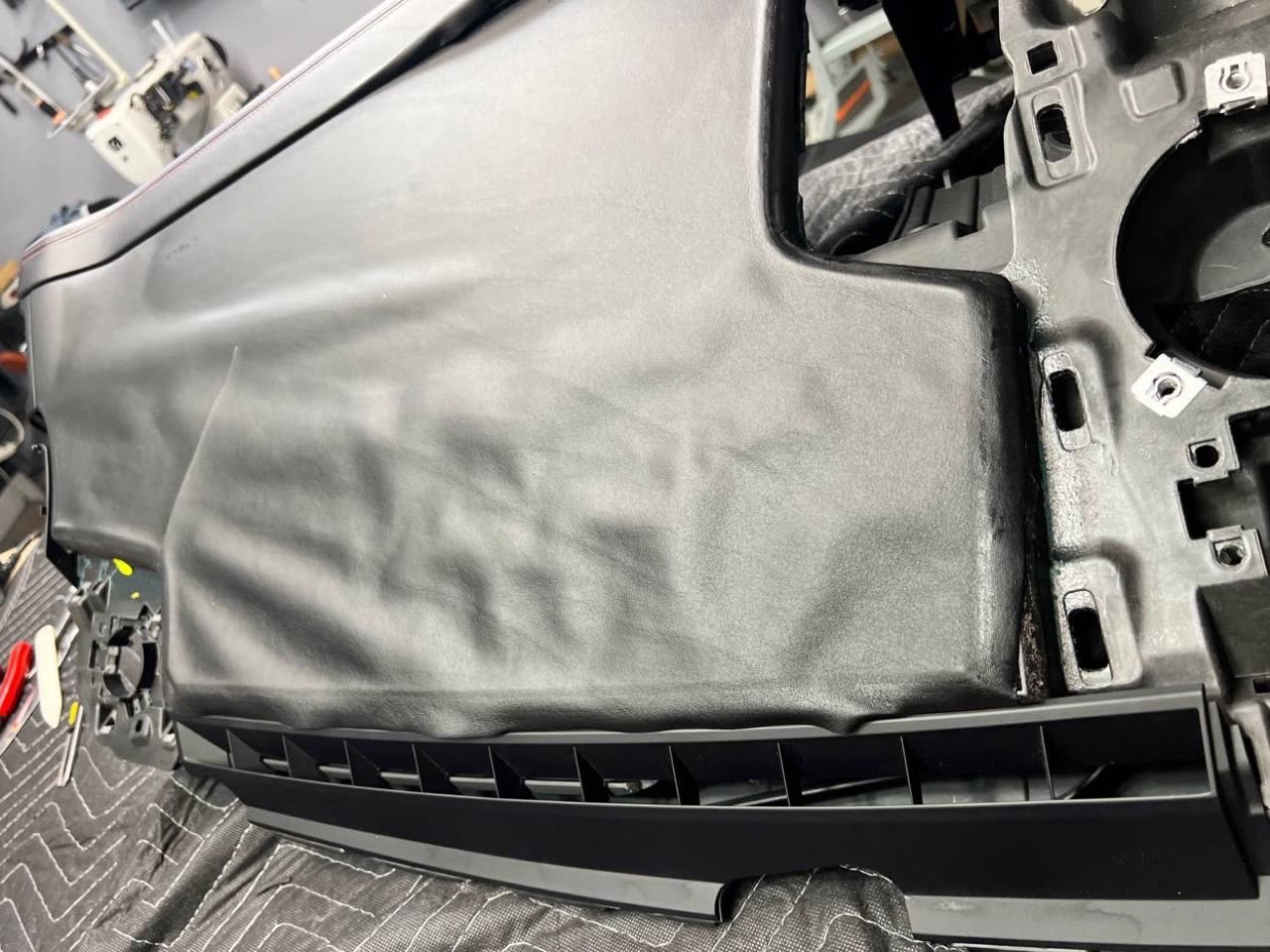Before: the same dashboard, end to end, the old leather