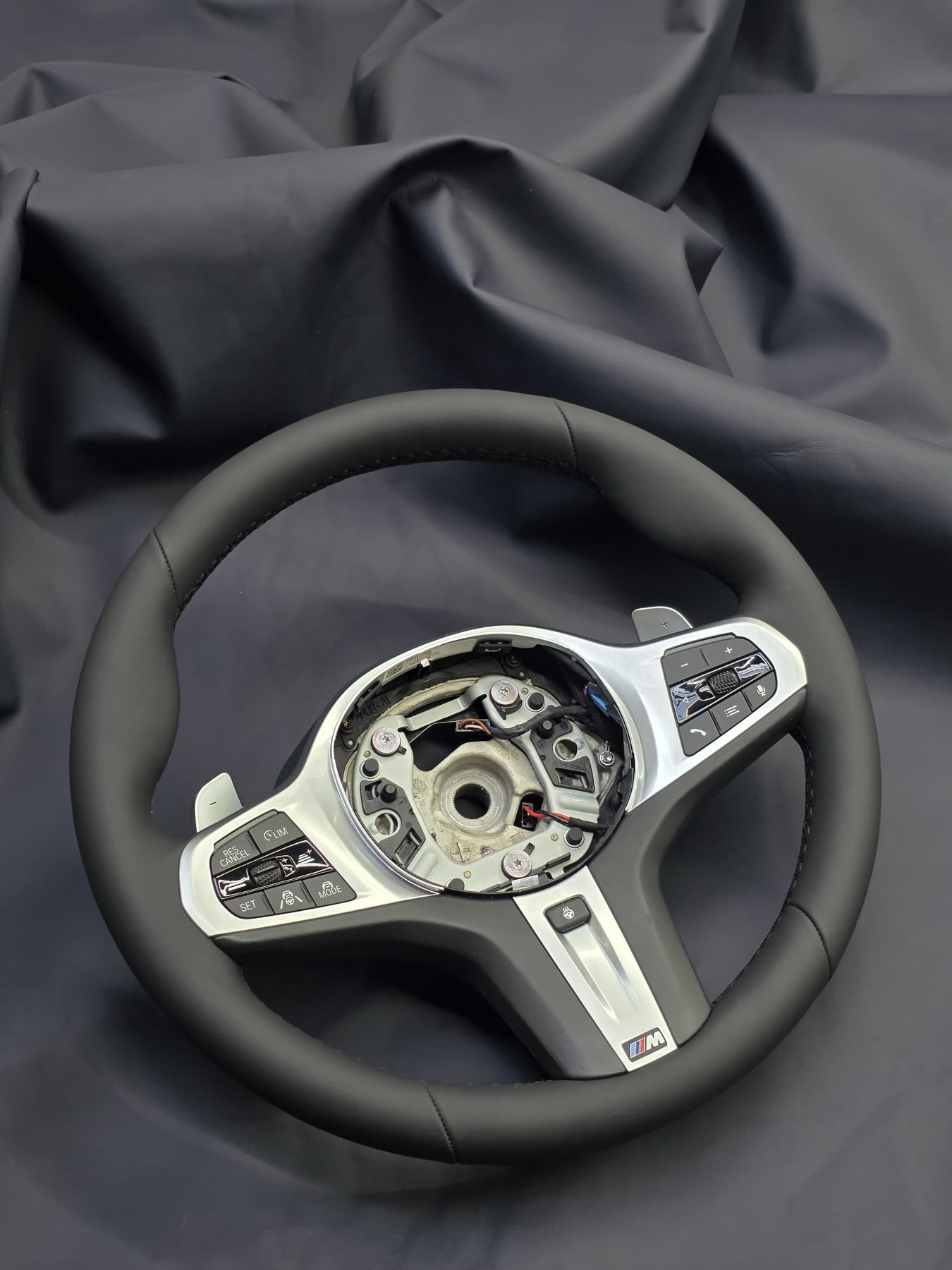 A BMW M steering wheel re-trimmed in smooth black leather