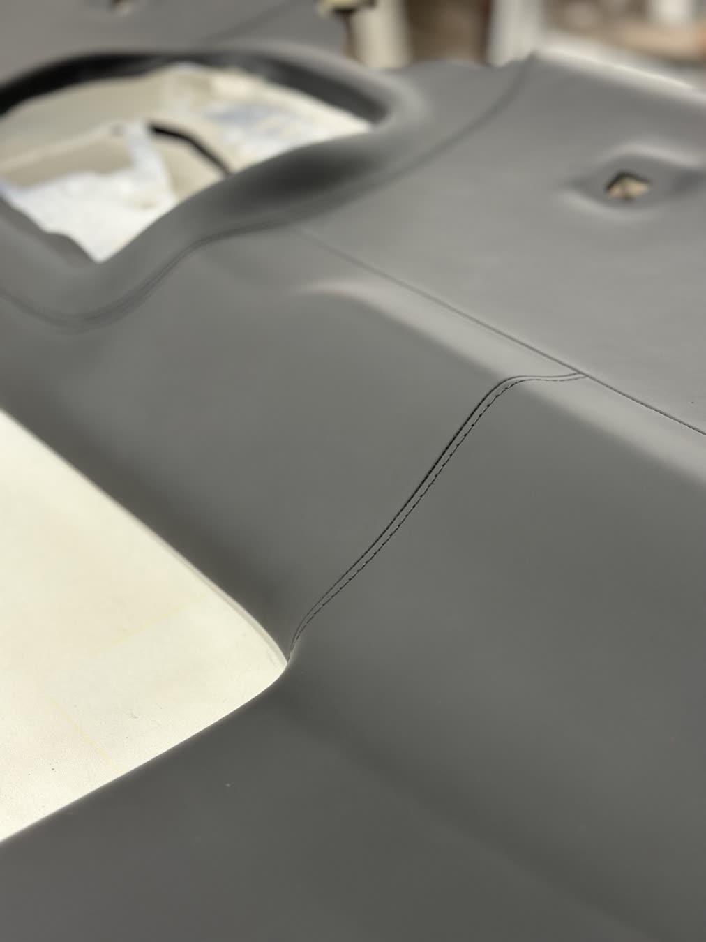 Black leather sides: Smooth black leather around the openings.