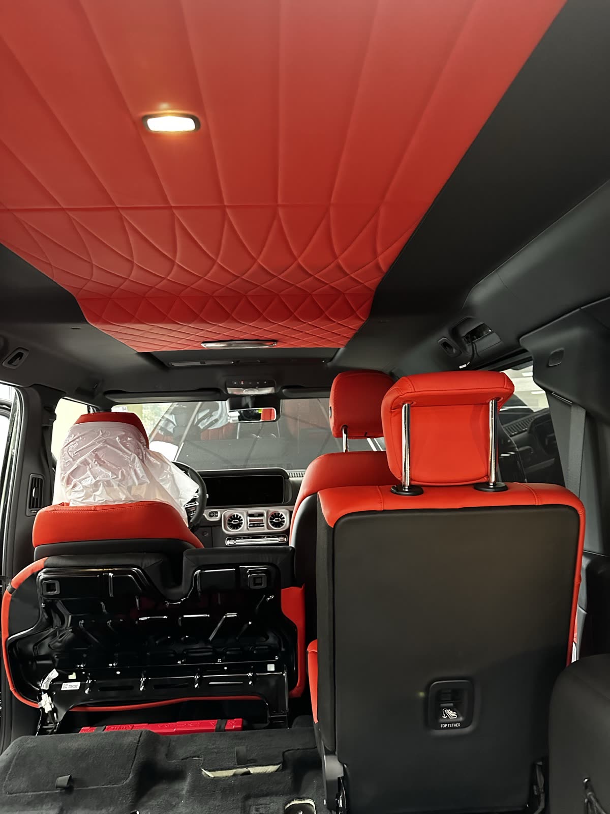 A G-Wagon headliner re-trimmed in red quilted leather with black leather sides