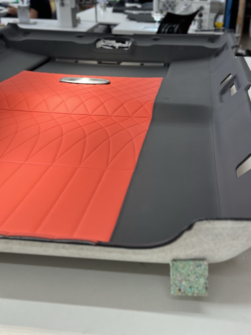 The quilting up close: A curved quilted pattern in red leather.