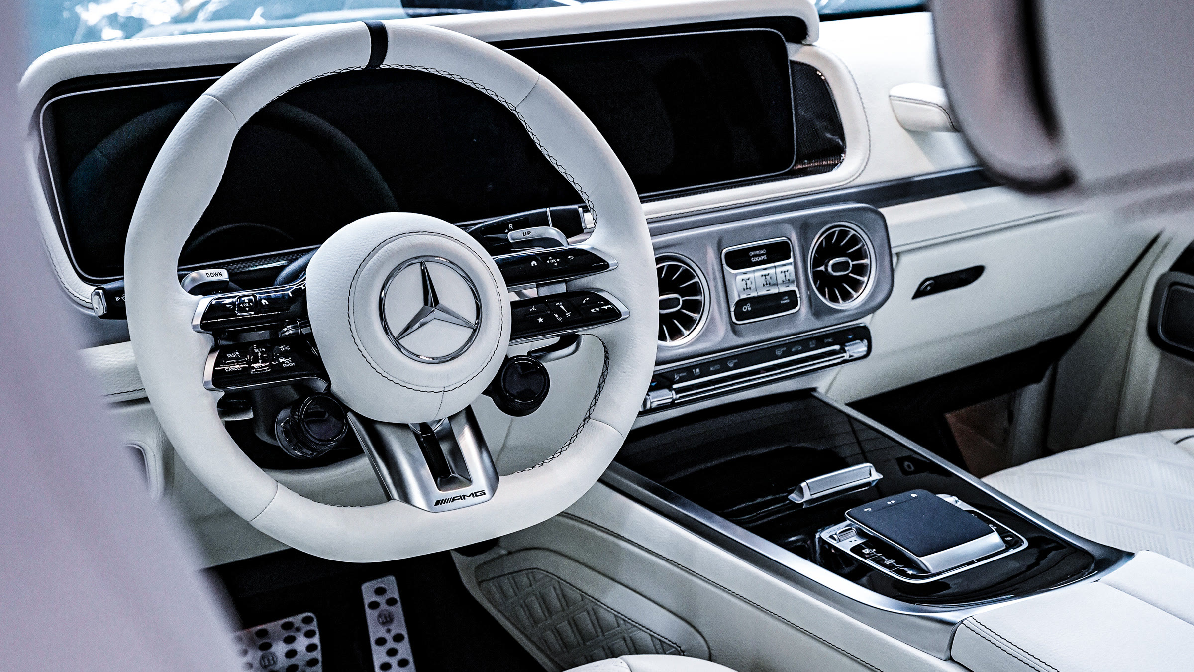 A Mercedes G 63 interior re-trimmed in our shop in white leather: steering wheel, dashboard and center console