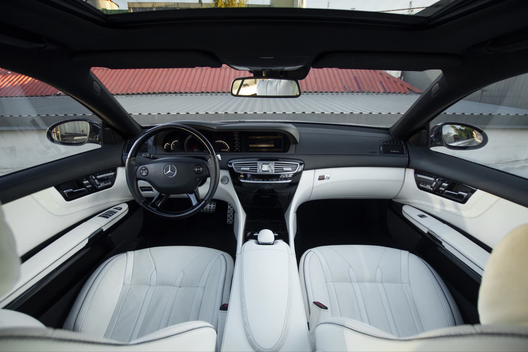 A Mercedes cabin in white and light grey leather seen from the back