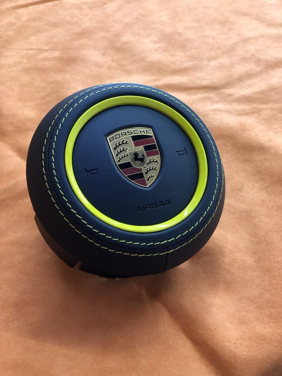 A Porsche airbag cover in navy leather with lime stitching
