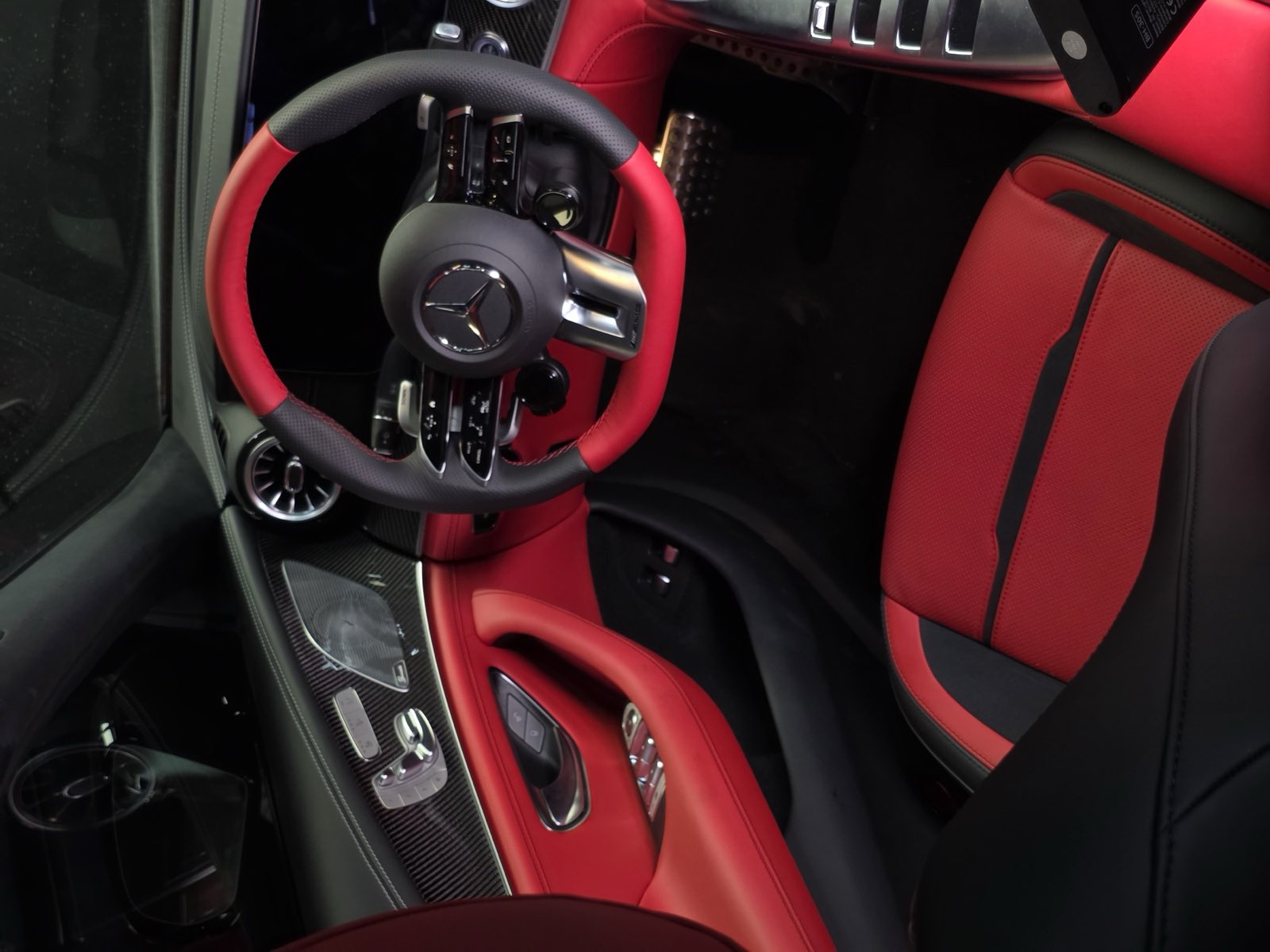 A Mercedes-AMG GT cockpit with red seats, red door panels and a red and black wheel