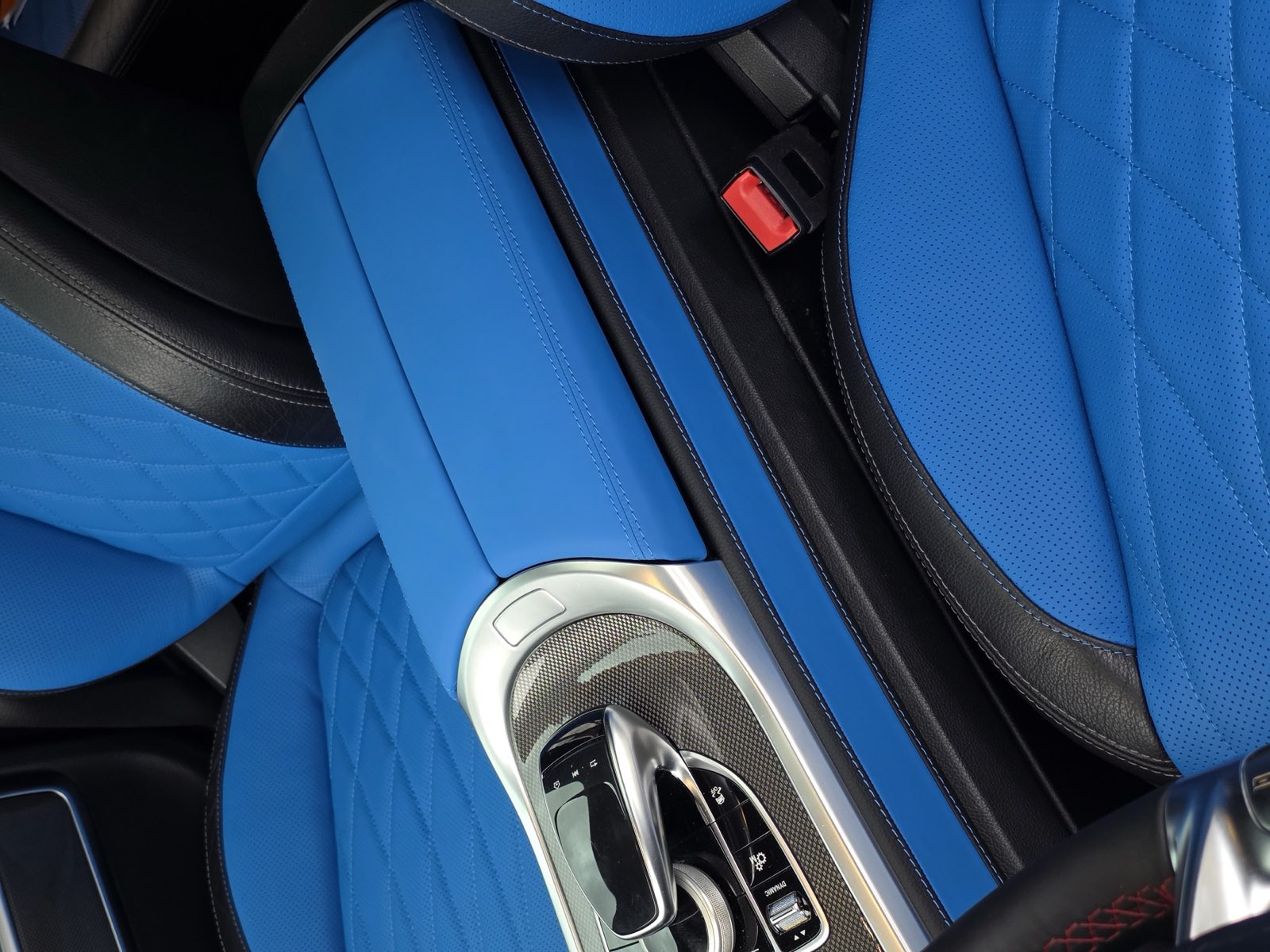 The center console in bright blue next to the seat