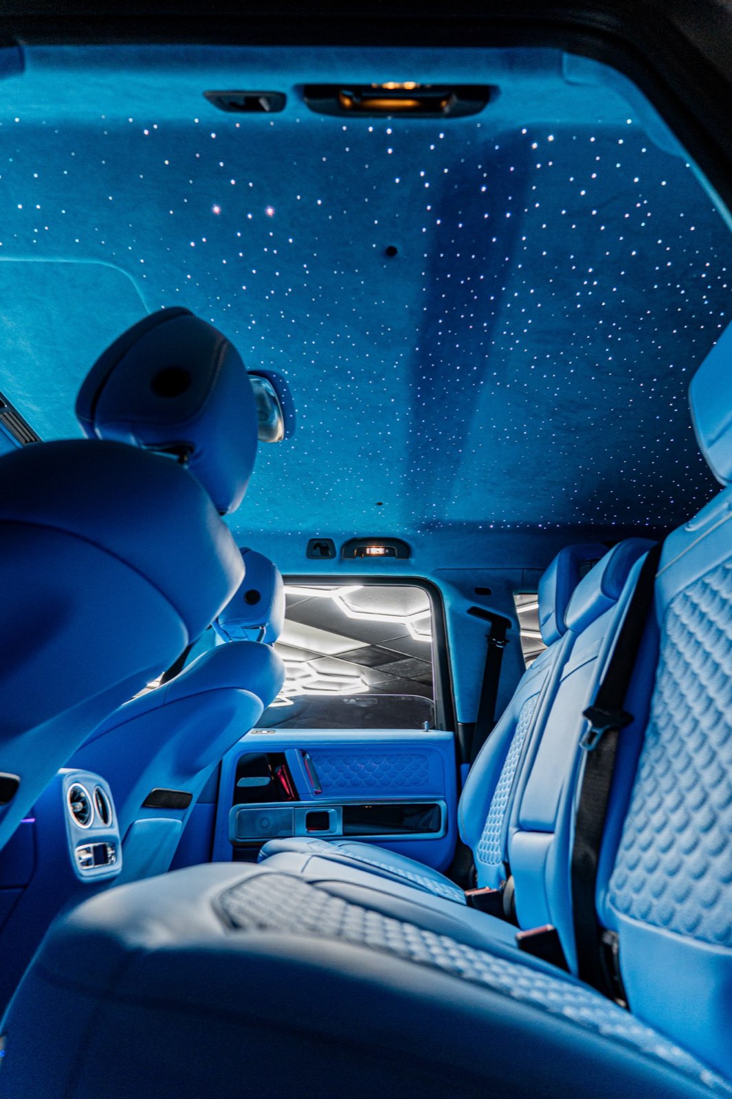The sky blue cabin seen from the rear seats under the stars