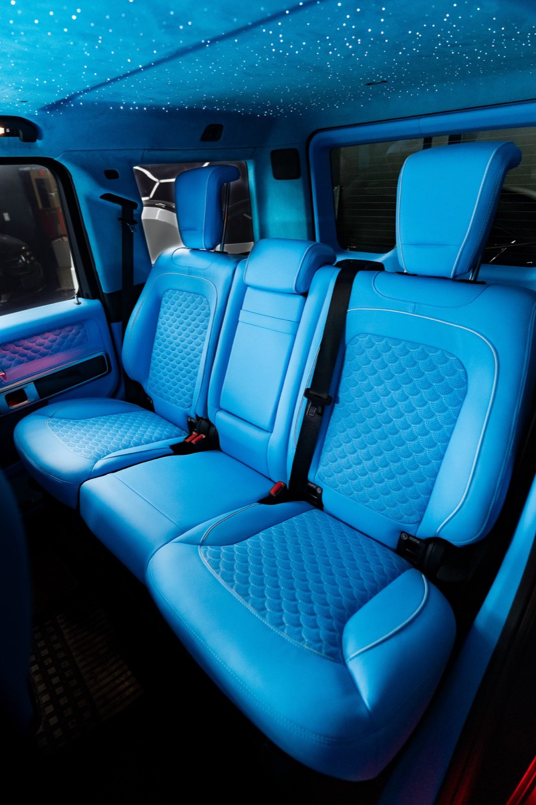 The rear bench of a G-Wagon in sky blue quilted leather