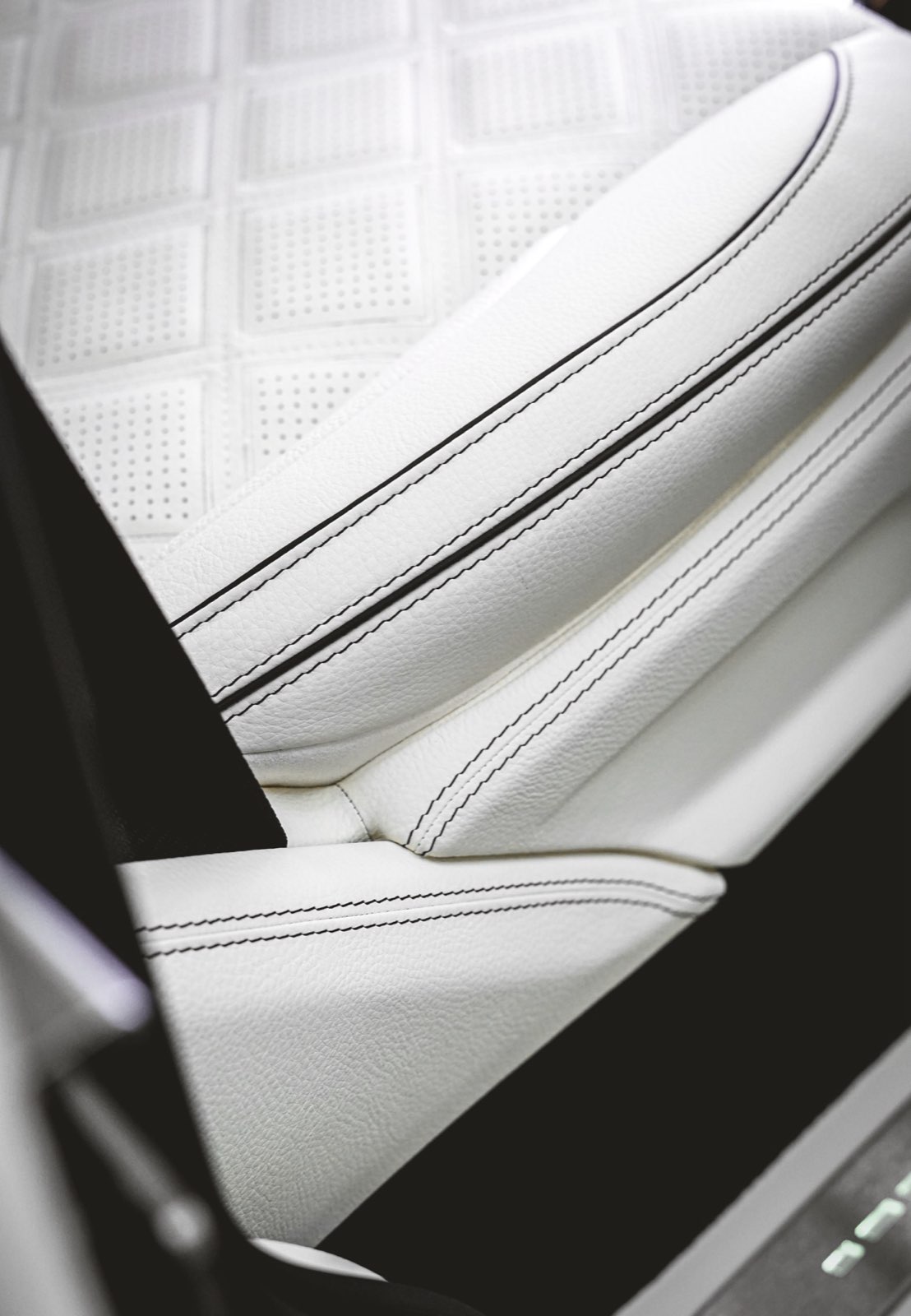 Dark piping: White leather and dark piping.