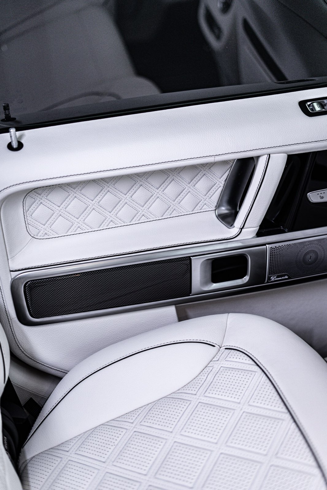 A white door panel and the quilted seat