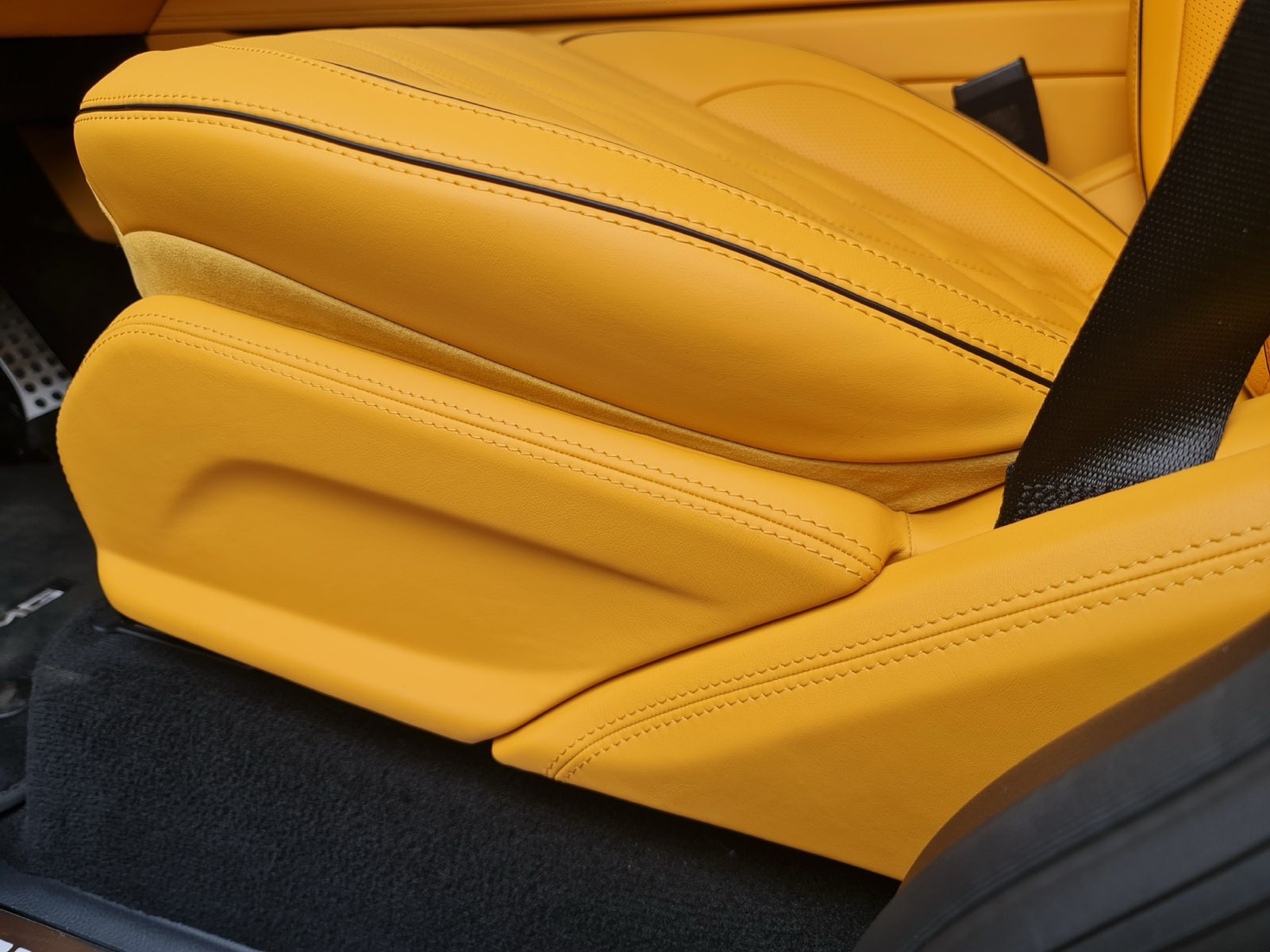 A yellow seat with fine stitching