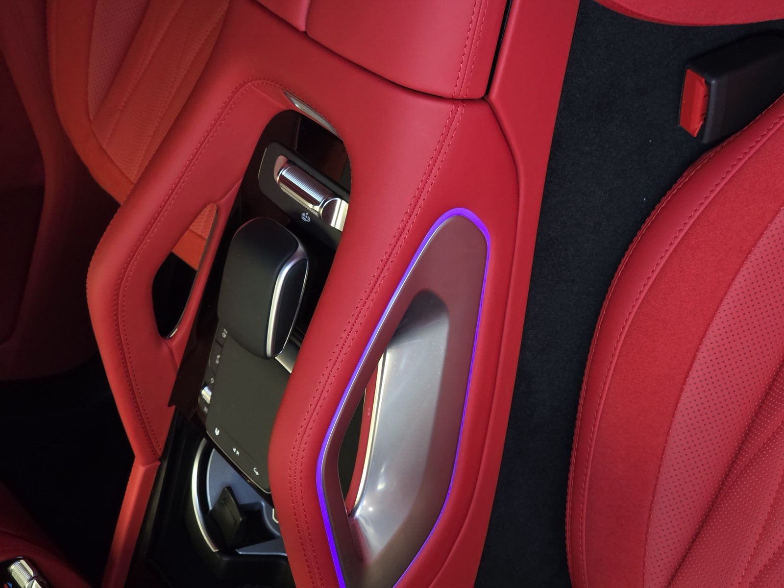 The center console in red leather with the ambient light