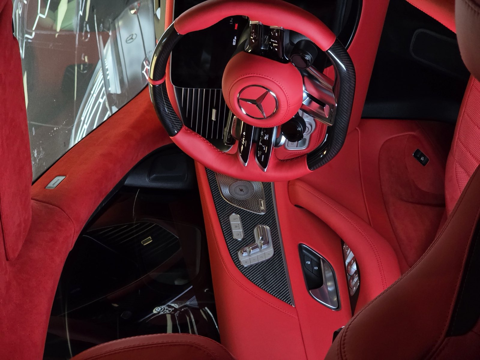 A red leather steering wheel and the dashboard behind it