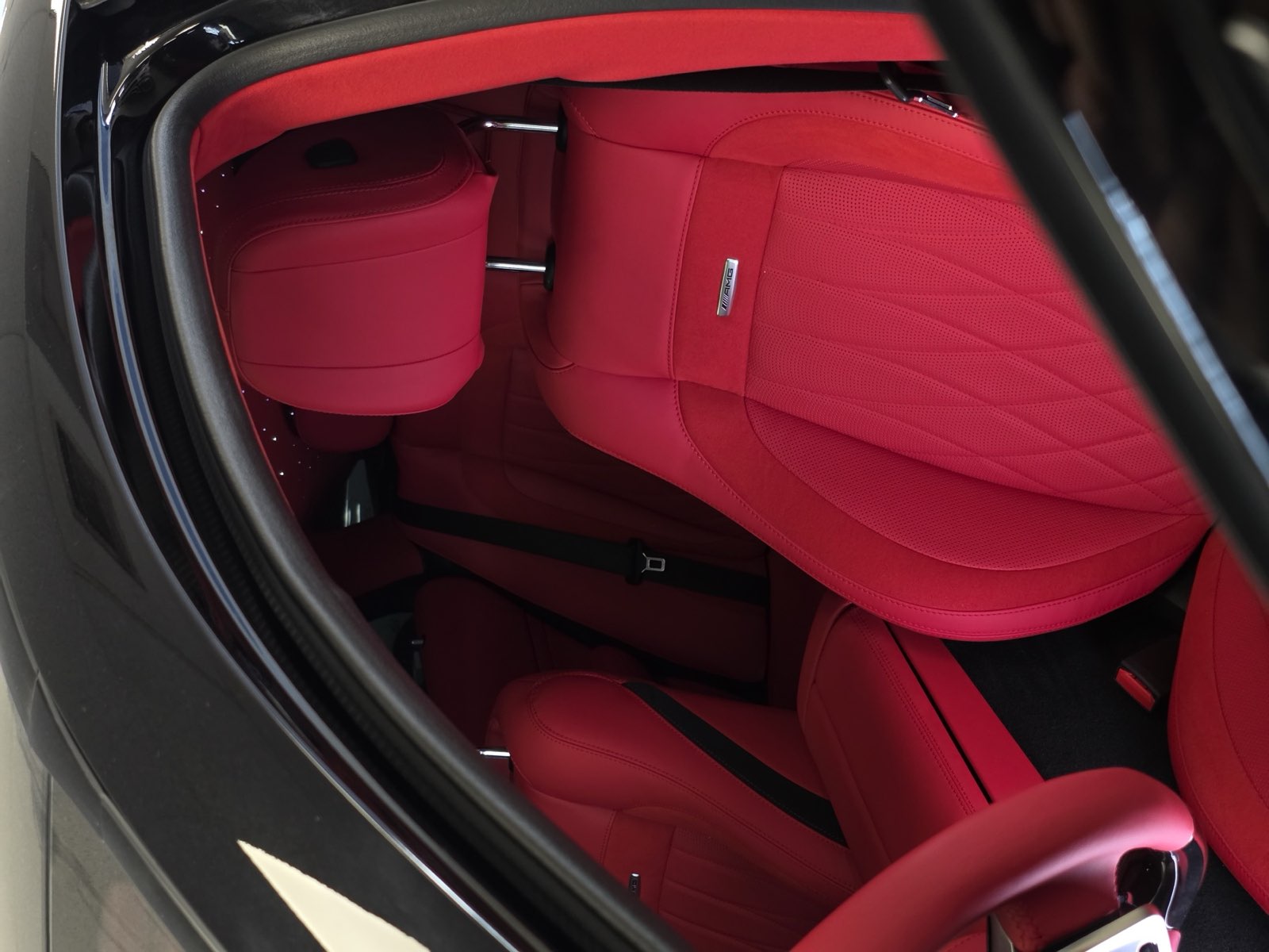 The red driver seat seen through the open door