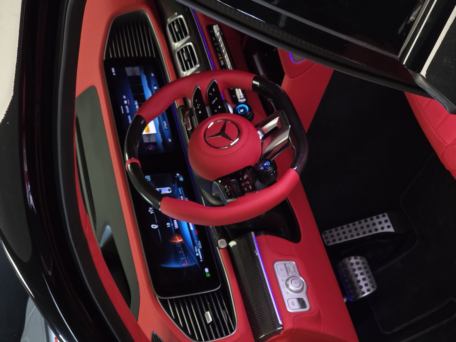 A Mercedes GLE cockpit with a red steering wheel, red dashboard and red seats
