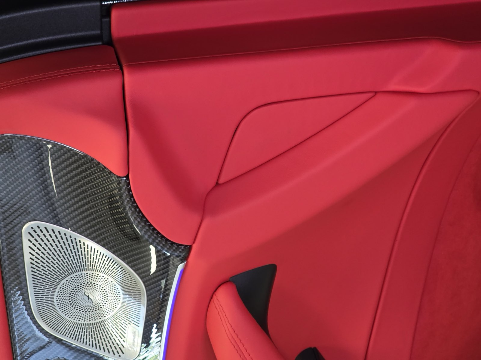 A red door panel next to the speaker grille