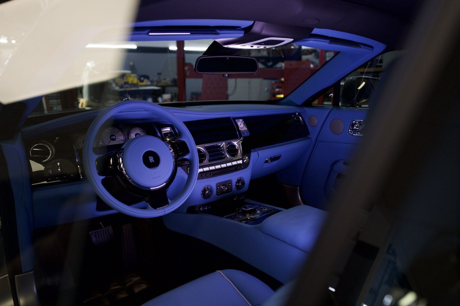 The royal blue dashboard and steering wheel of a Rolls-Royce