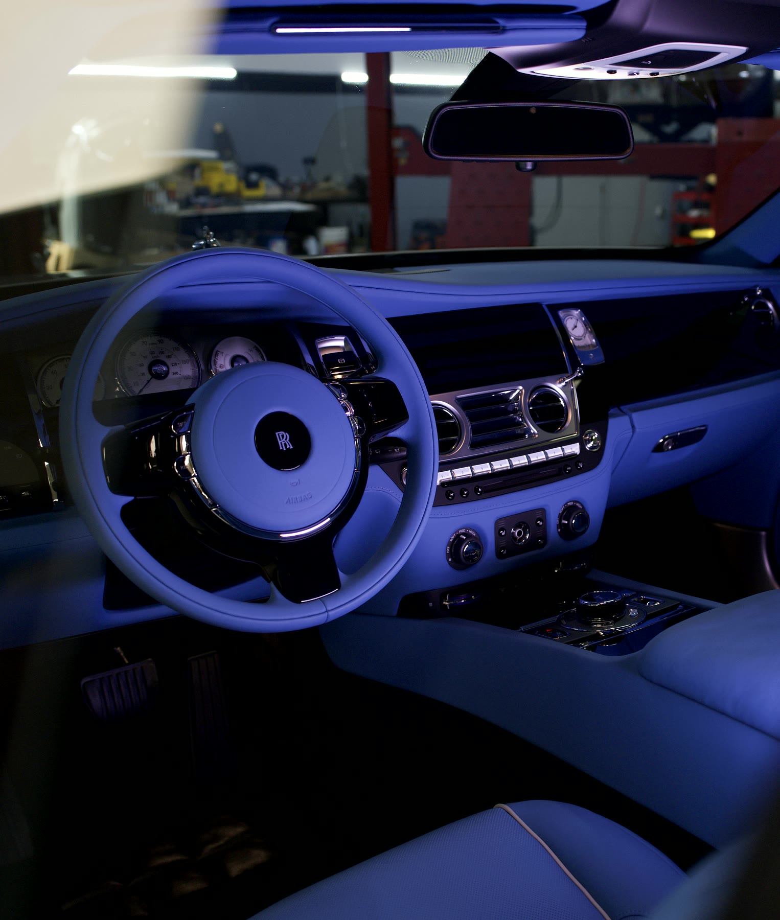 A Rolls-Royce cabin in royal blue leather, with the steering wheel and the dashboard to match