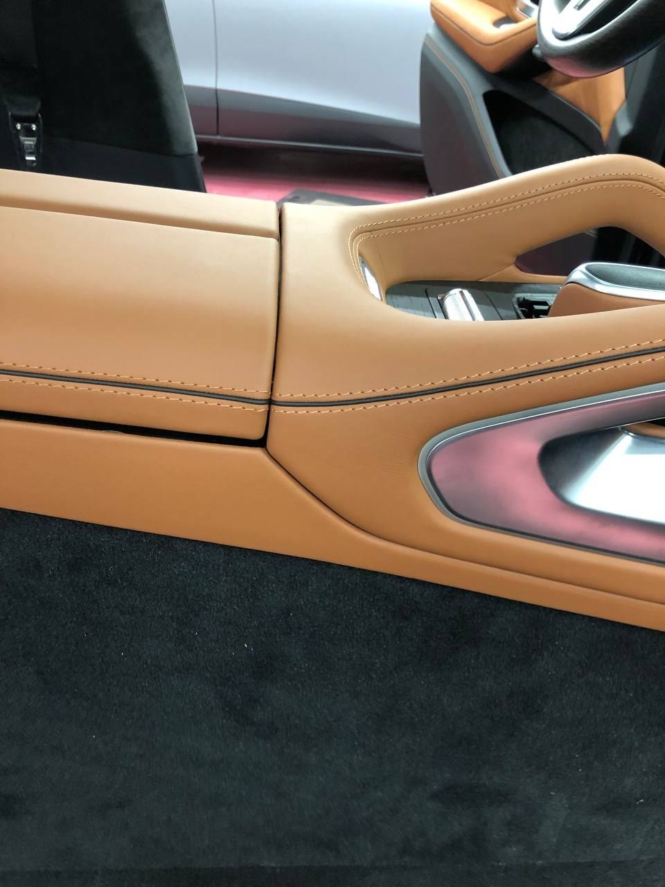 A center console in tan leather with dark stitching
