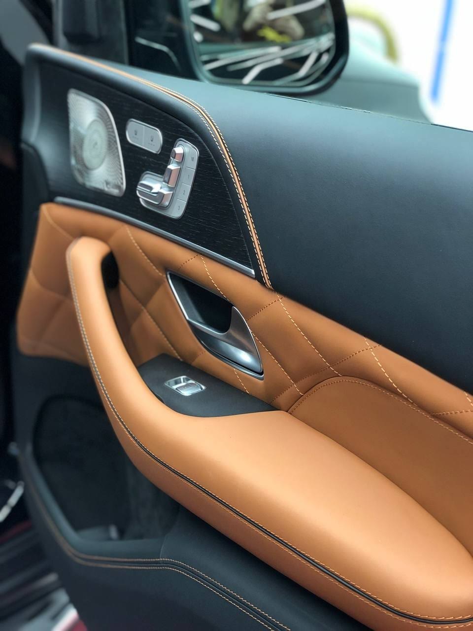 A door panel in tan leather with a quilted insert