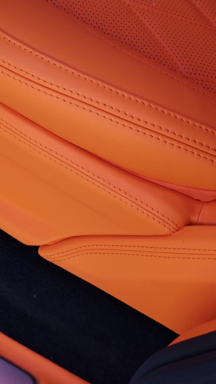 Orange leather with a fine double stitch, filmed in the shop.