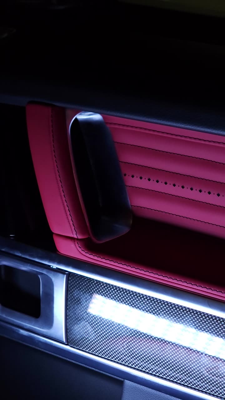 A G-Wagon door panel in red quilted leather with the lit sill